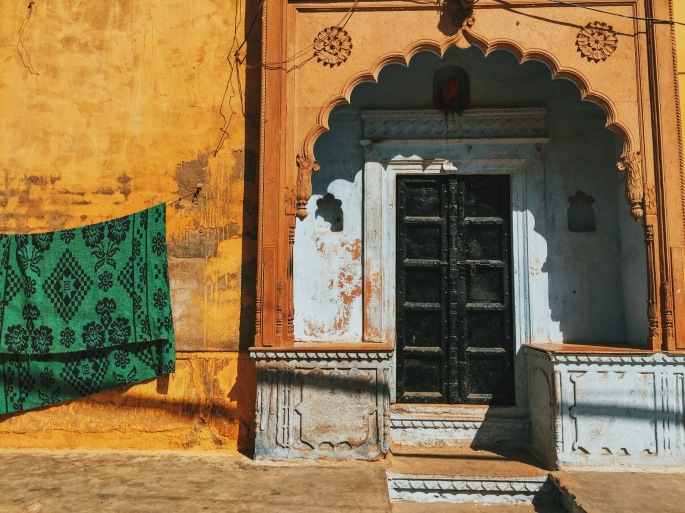 A simple sari hung on a wall in a village.